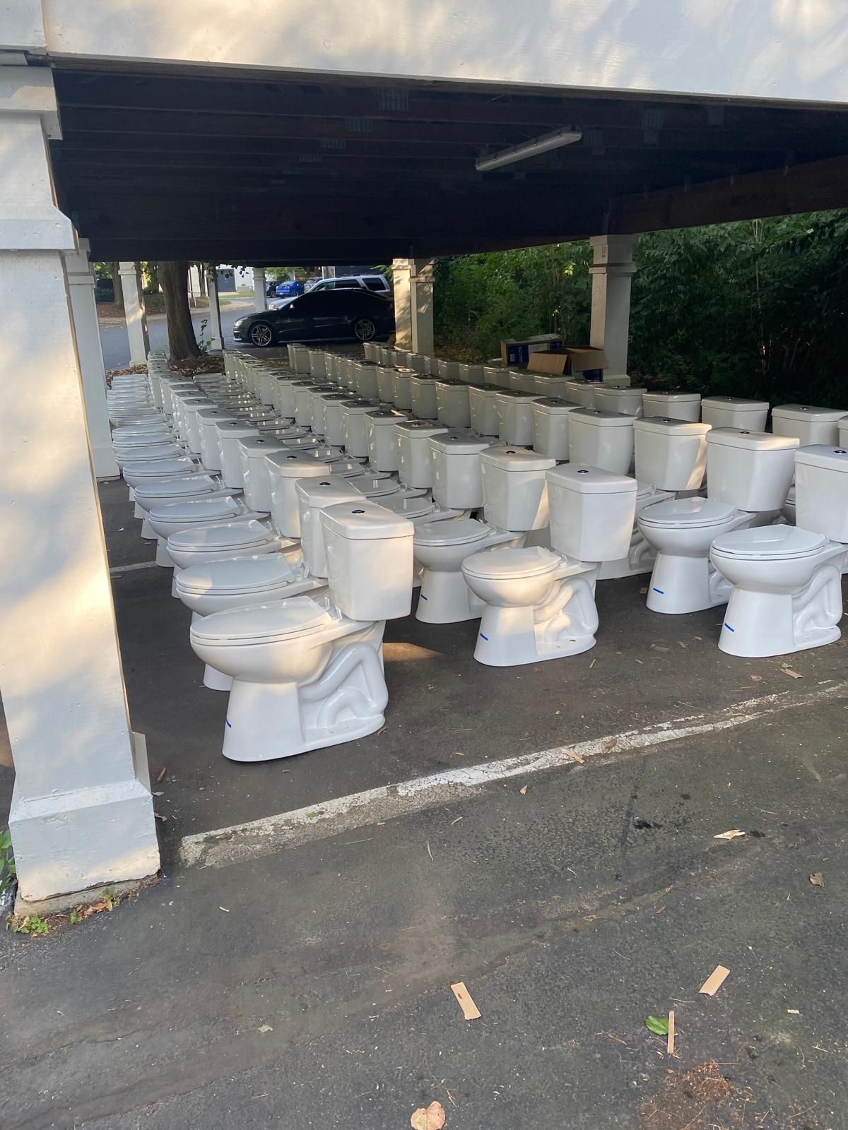 Rows of new high-efficiency toilets ready for multifamily installation